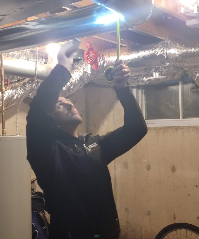 home inspector checks basement ceiling